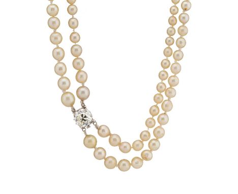 A mid 20th century graduated cultured pearl two-row necklace, with old-cut diamond single-stone clasp, diamond estimated weig