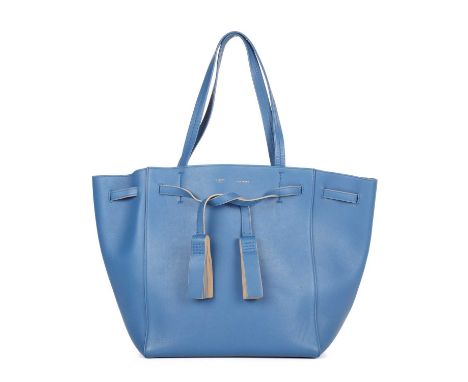 Celine, a Phantom Tassel tote, crafted from blue calf leather, featuring dual leather handles, tasselled wraparound belt deta