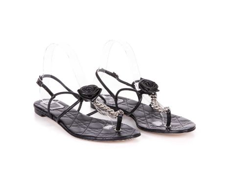 Christian Dior, a pair of unworn black leather thong sandals, featuring a leather central rosette, silver-tone T-strap chain 