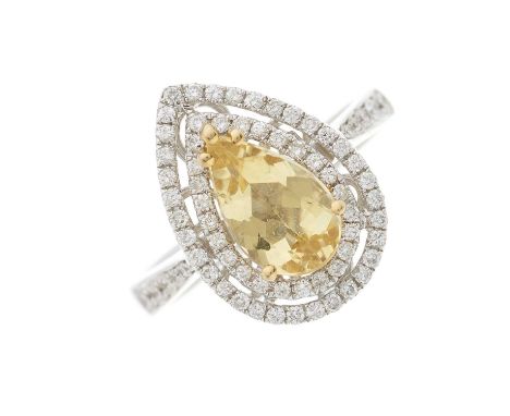 An 18ct gold heliodor and brilliant-cut diamond cluster ring, with similarly-cut diamond line shoulders, heliodor weight 1.34