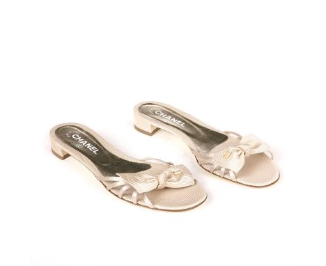 Chanel, a pair of unworn Grosgrain Bow sandals, crafted from beige satin grosgrain, with bow detail with pearl embellished CC