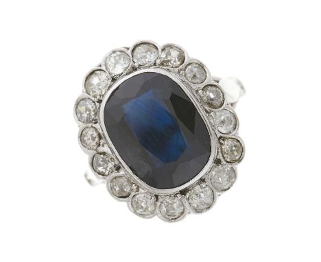 A mid 20th century sapphire and old-cut diamond cluster dress ring, with stylised fleur-de-lys shoulders, sapphire estimated 