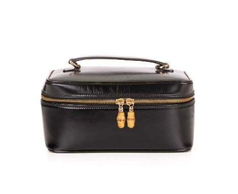 Gucci, a Bamboo vanity case, crafted from smooth black leather, with gold-tone hardware, single black leather top handle, and