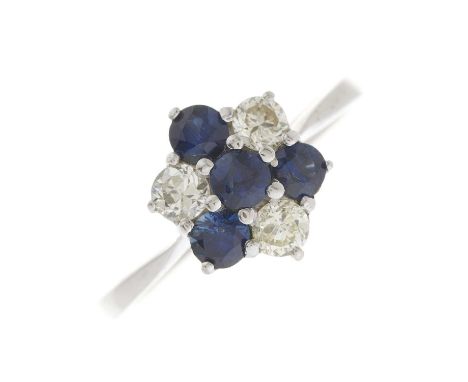 A mid 20th century sapphire and circular-cut diamond floral cluster ring, with tapered shoulders, estimated total diamond wei