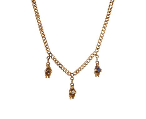 An early 20th century 15ct gold curb-link necklace, suspending three bear charms, each holding a diamond, a sapphire or a rub