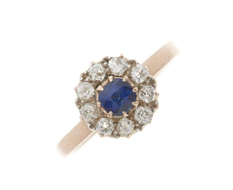 A gold cushion-shape sapphire and old-cut diamond cluster ring, estimated total diamond weight 0.60ct, ring size O1/2, 2.5gOv