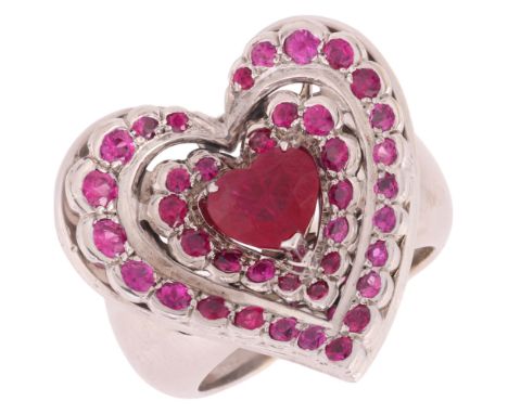 NOURBEL - A Ruby Heart Ring,set with a central heart cut ruby surrounded by two rows of round cut rubies, mounted in 18ct whi