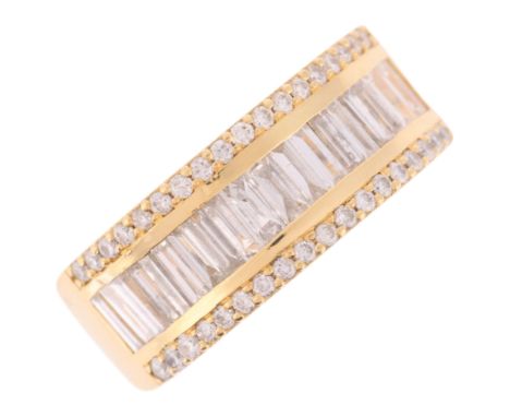 A Diamond Band Ring,channel set with central row of baguette cut diamonds, flanked either side by a row of round brilliant cu