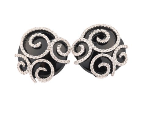 A Pair of Onyx and Diamond Earrings, the spheroid onyx panel mounted with diamond set spiral frame, having clip and post fitt