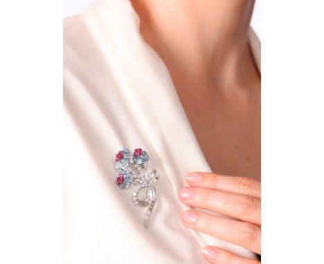 An Aquamarine, Ruby and Diamond Floral Spray Brooch,circa 1950s, set with pear cut aquamarine petals, round cut ruby stamen w