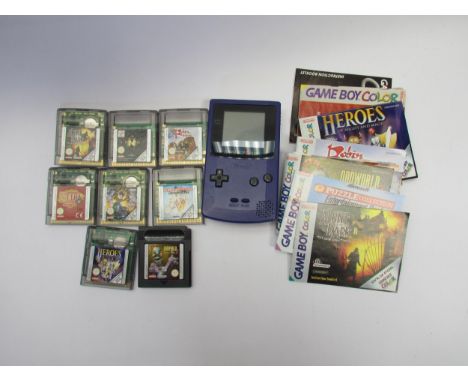 A Nintendo Game Boy Color handheld computer games console with instruction booklet and eight games and manuals to include Odd