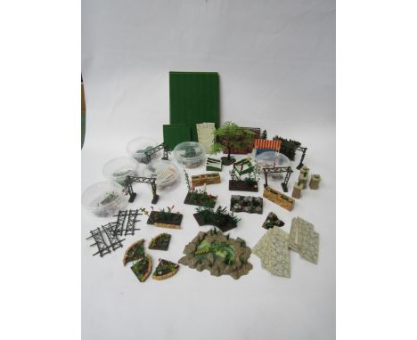 A collection of Britains Floral Garden range items to include two wheelbarrows, lawn mower, sprinkler, two lawn rollers, two 