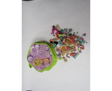 A Tara Polly Pocket carry case containing assorted Mattel Polly Pocket dolls and outfits 