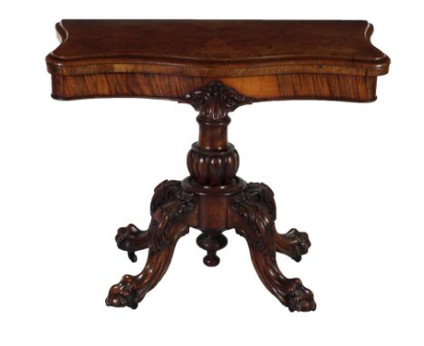 A fine quality Victorian walnut serpentine shaped fold-over Card Table, the frieze with central decoration on a cylindrical b