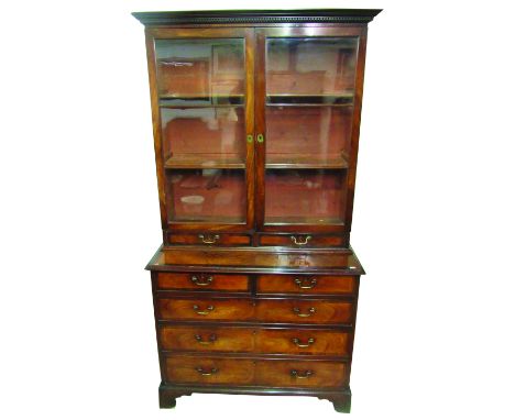 A desirable Irish Georgian period mahogany Bookcase on Chest, the dentil moulded cornice over two glazed doors with brass esc