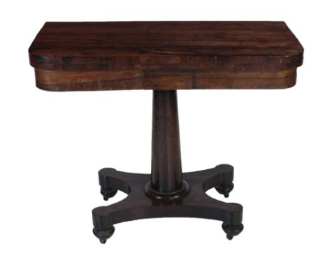 A 19th Century rosewood fold-over Card Table, the plain top supported by a cylindrical pillar on quatre form base and brass c