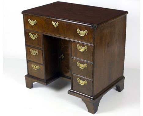 An attractive 18th Century period walnut kneehole Bachelors Desk, with crossbanded top, over a recessed cupboard and an arran