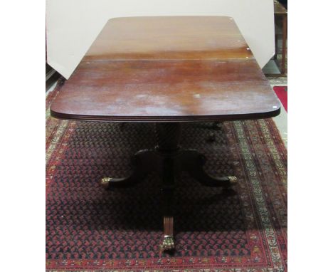 A Georgian style mahogany extendable two pod Dining Table, with extra leaf on tripod bases with rope turned supports on outsp