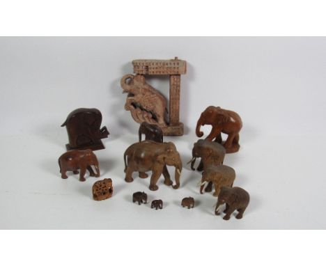 A large herd of Elephants, various sizes, in teak, mahogany and other Oriental woods, etc., one shaped into a bracket, approx