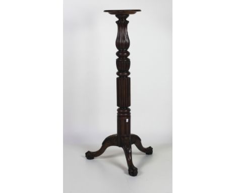 A 19th Century carved mahogany Torchere, with reeded decoration on tripod base with acanthus leaf decoration on ball n' claw 