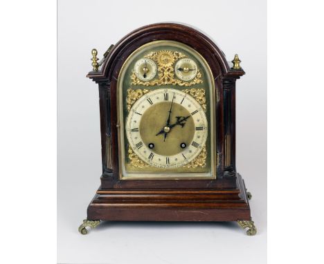 An Edwardian oak and brass dial German Bracket Clock for Morath Bros., Liverpool, the arched dial with three movements, and e