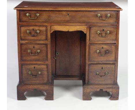 A 19th Century mahogany kneehole Bachelors Chest, the moulded top over a long frieze drawer and central kneehole flanked eith