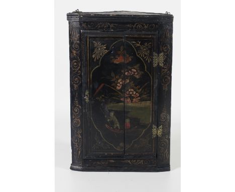 A 19th Century lacquered Corner Cabinet, in the Chinese taste, with decorated panel door highlighted in gilt, approx. 87cms (