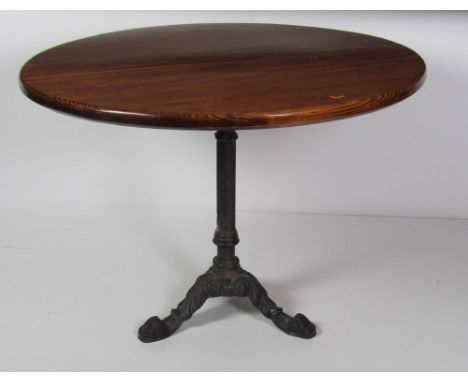 A large circular Breakfast Table, on stained pine top with earlier metal tripod base, approx. 102cms (40"). (1)