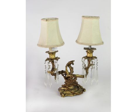 An attractive rococo decorated heavy ormolu two branch Table Light, with cutglass drops. (1)