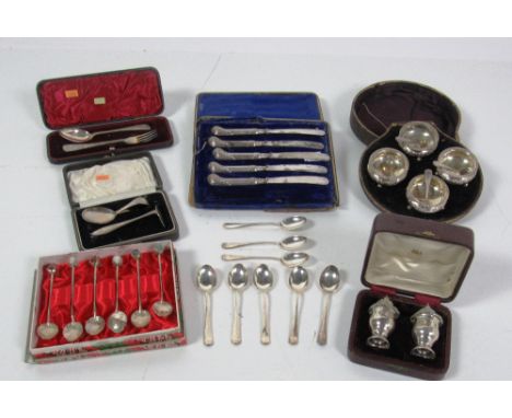 A cased set of four circular silver Salts, with four matching salt spoons, a cased pair of Irish silver Salt and Pepper Shake