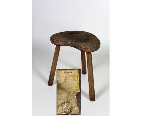 A 20th Century oak tripod Stool, by Robert Thompson, (the Mouseman), designed in the joiners style with horseshoe shaped seat