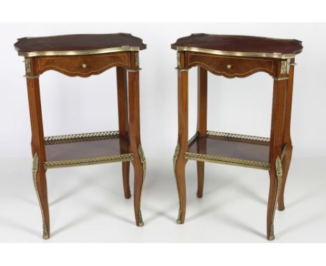 An attractive pair of kingwood French style two tier Lamp Tables, the shaped inlaid top with brass rim over frieze drawer on 