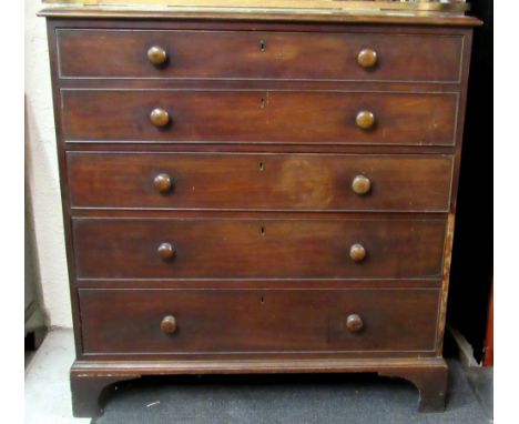 A late Georgian period Irish mahogany Secretaire Chest, the top two drawers dropping to reveal a fitted interior, over three 