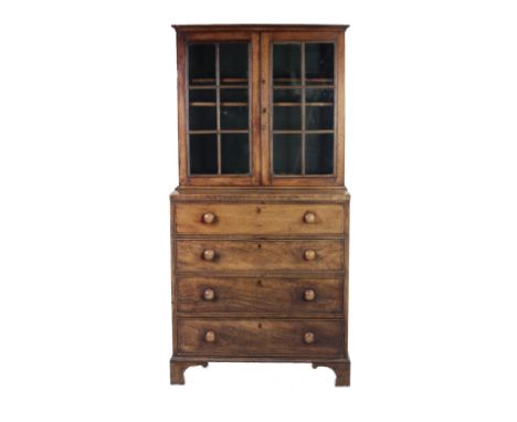 A good 19th Century Irish mahogany Bookcase on Chest, of small proportions, the plain top with glazed doors on a base with fo