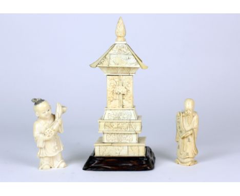 A 19th Century Chinese ivory pagoda type Shrine, with two Netsuke figures modelled as a young boy selling flowers and an elde