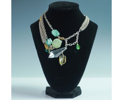 A striking and bold statement necklace featuring an avant-garde combination of mixed metal chains, raw-cut gemstones, and fac