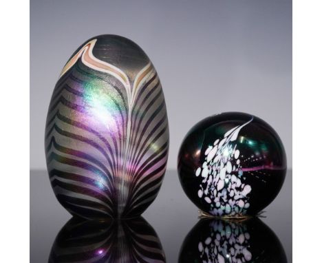 Striking duo of hand-crafted art glass paperweights featuring captivating color and design. The smaller piece is a signed Bal