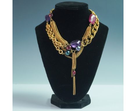 A striking 16-inch gold-toned multi-strand necklace featuring a layered combination of textured and smooth chains, adorned wi