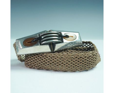 A unique vintage women's belt featuring an intricately woven textile strap paired with a striking Art Deco-style metal buckle