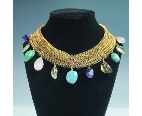 A bold and artistic gold-toned mesh collar necklace adorned with faceted semi-precious stone drops in a variety of vibrant hu