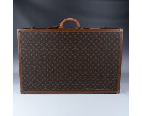 Vintage Louis Vuitton monogram canvas hard-sided suitcase, featuring the iconic LV monogram design, reinforced leather trim, 