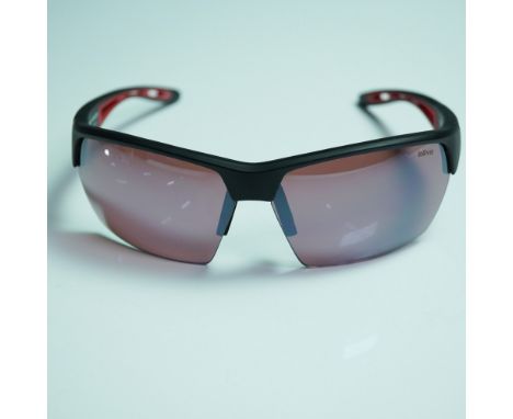 Sporty and functional, these Revo Jett polarized sunglasses feature a sleek wraparound frame in matte black with red accents 