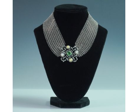 A striking choker necklace by designer Connie Bates, featuring an intricate silver-tone mesh collar adorned with a bold geome