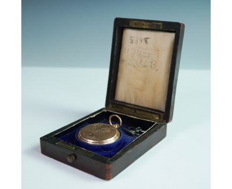 This finely crafted antique gold pocket watch by Ami Richard features an ornately engraved case with intricate scrollwork, a 