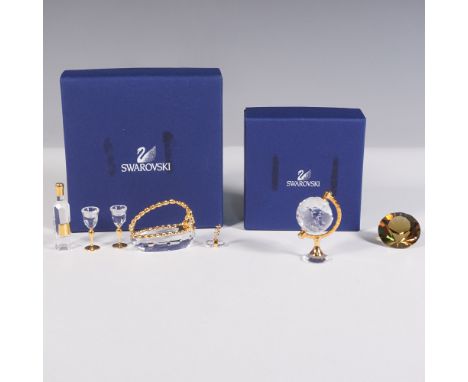 This set includes two Swarovski crystal collections featuring gold-tone accents. The first collection showcases a miniature c
