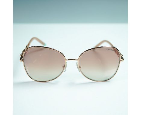 Stylish Tiffany &amp; Co TF3086 sunglasses featuring a rose gold-tone metal frame with a soft cat-eye silhouette and gradient