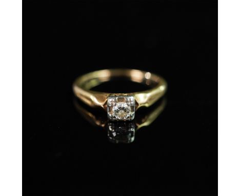 An exquisite vintage gold solitaire ring featuring a genuine diamond, set in a uniquely detailed white gold illusion-style se
