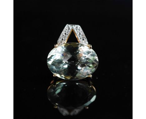 A striking 14K gold pendant showcasing a brilliant oval-cut green amethyst in a secure openwork setting. The faceted gemstone