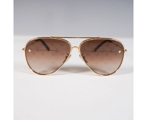 A sophisticated pair of Louis Vuitton aviator sunglasses featuring the brand's iconic monogram pattern subtly etched into the