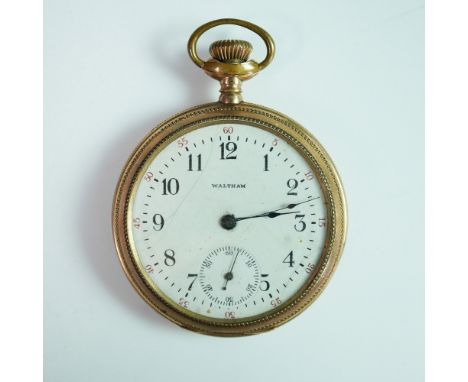 An antique Waltham pocket watch with a gold case, featuring an engraved presentation dedication reading: â€œPresented to M.J.